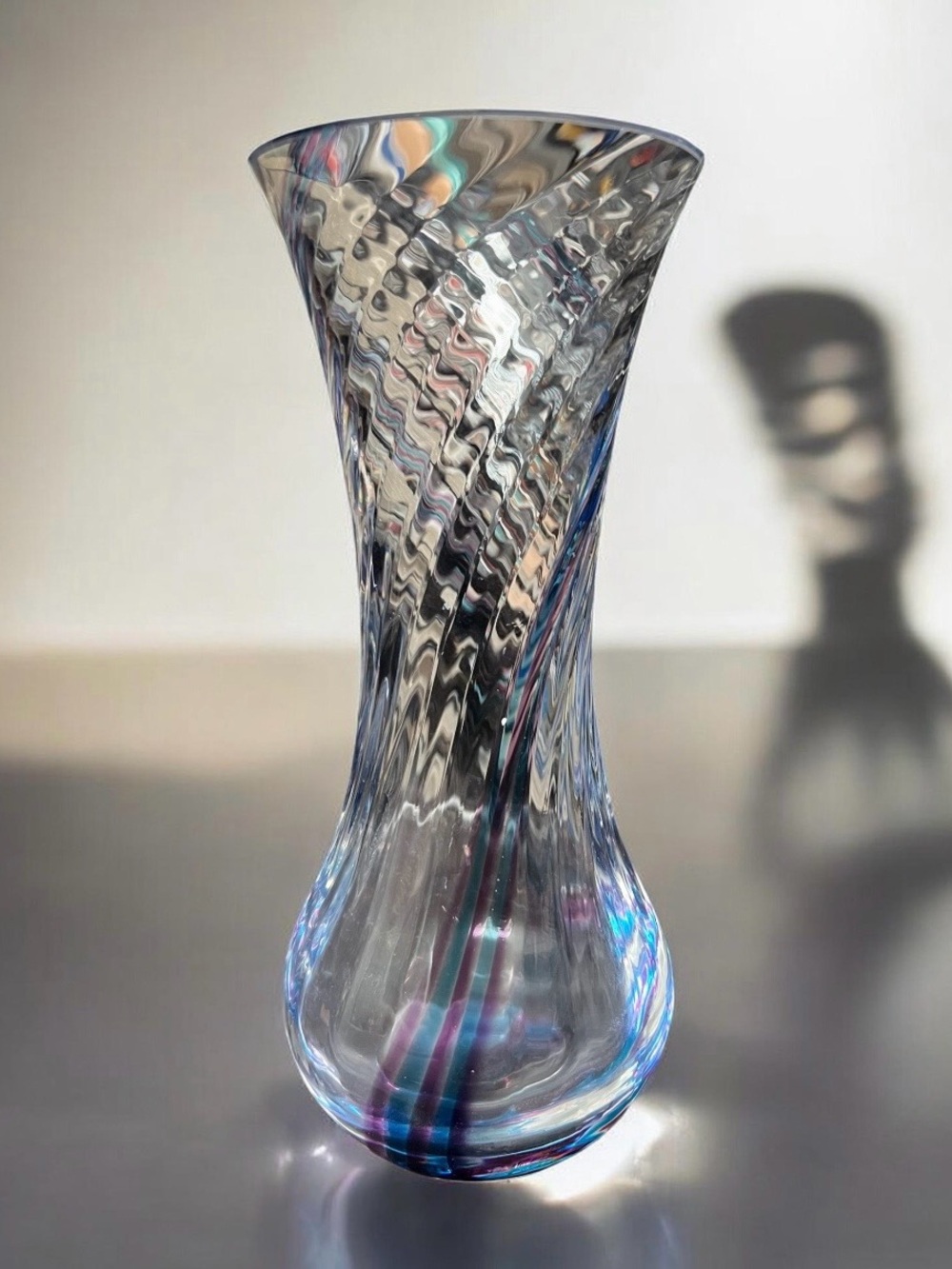 vintage Caithness hand blown vase with a swirled clear, blue, and purple pattern